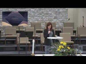 Accessible church service at New Albany United Methodist Church with a woman speaking at the pulpit.